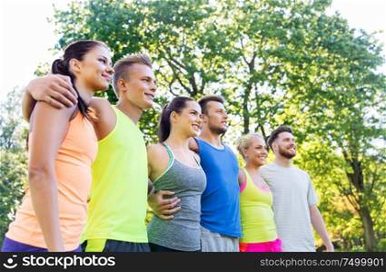 fitness, sport and healthy lifestyle concept - group of happy friends or sportsmen at summer park. group of happy friends or sportsmen at summer park