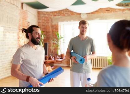fitness, sport and healthy lifestyle concept - group of people with mats at yoga studio or gym. group of people with mats at yoga studio or gym. group of people with mats at yoga studio or gym