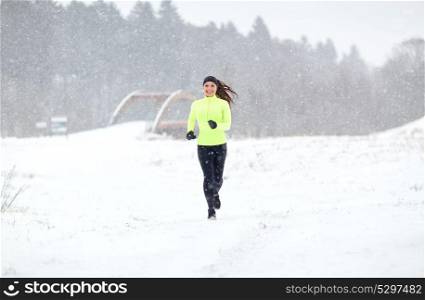 fitness, sport and healthy lifestyle concept - happy smiling woman running outdoors in winter. happy smiling woman running outdoors in winter