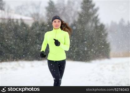 fitness, sport and healthy lifestyle concept - happy woman running outdoors in winter. happy woman running outdoors in winter
