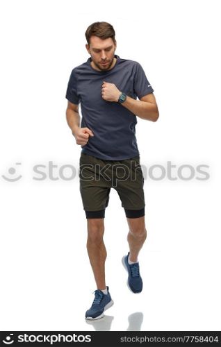 fitness, sport and healthy lifestyle concept - man in sports clothes with smart watch or tracker running over white background. running man in sports clothes with smart watch
