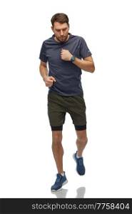 fitness, sport and healthy lifestyle concept - man in sports clothes with smart watch or tracker running over white background. running man in sports clothes with smart watch