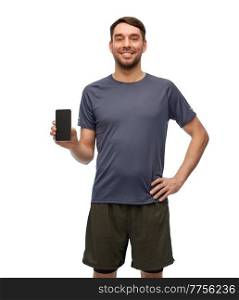 fitness, sport and healthy lifestyle concept - smiling man in sports clothes showing smartphone over white background. smiling man in sports clothes showing smartphone