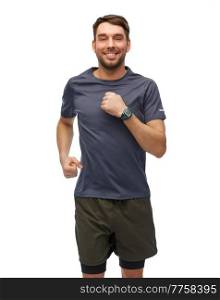 fitness, sport and healthy lifestyle concept - smiling man in sports clothes with smart watch or tracker running over white background. smiling running man in sports clothes
