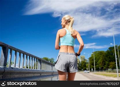 fitness, sport and healthy lifestyle concept - sporty young woman running outdoors. sporty young woman running outdoors