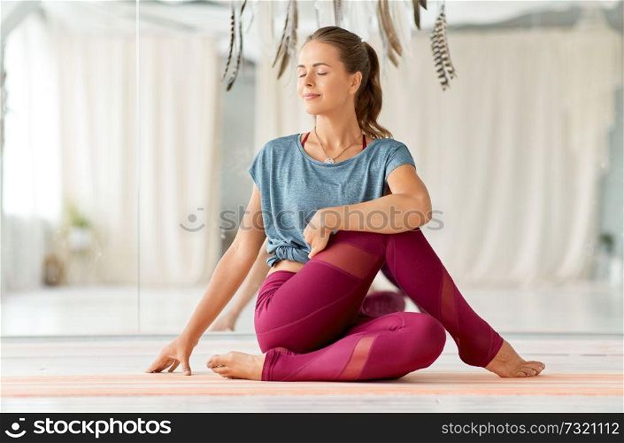 fitness, sport and healthy lifestyle concept - woman doing yoga exercise at studio. woman doing yoga exercise at studio