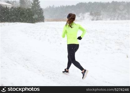 fitness, sport and healthy lifestyle concept - woman running outdoors in winter. woman running outdoors in winter