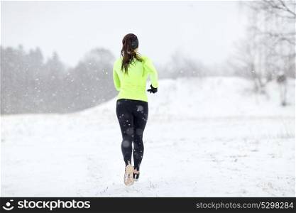 fitness, sport and healthy lifestyle concept - woman running outdoors in winter. woman running outdoors in winter