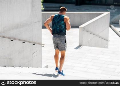 fitness, sport and healthy lifestyle concept - young man running downstairs. young man running downstairs