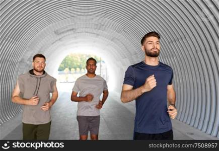fitness, sport and healthy lifestyle concept - young men or male friends running outdoors. young men or male friends running outdoors