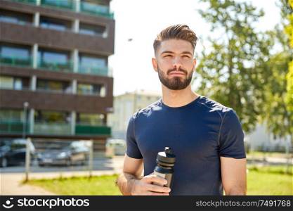 fitness, sport and healthy lifestyle concept - young sporty man with bottle outdoors. young sporty man with bottle outdoors