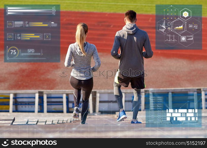 fitness, sport and people concept - couple walking downstairs on stadium. couple walking downstairs on stadium