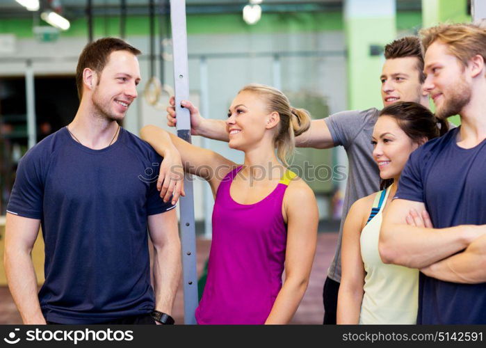 fitness, sport and people concept - group of happy friends in gym. group of happy friends in gym