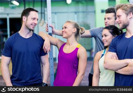 fitness, sport and people concept - group of happy friends in gym. group of happy friends in gym