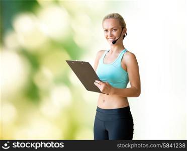 fitness, sport and people concept - happy woman sports trainer with microphone and clipboard over green natural background