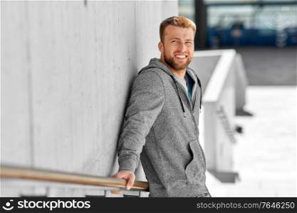 fitness, sport and people concept - portrait of happy smiling young man outdoors. portrait of happy smiling young man outdoors