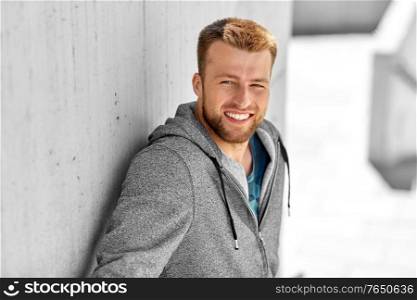 fitness, sport and people concept - portrait of happy smiling young man outdoors. portrait of happy smiling young man outdoors