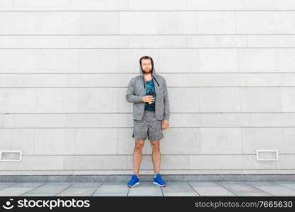 fitness, sport and people concept - young man with bottle of water in city. sportsman with bottle of water in city