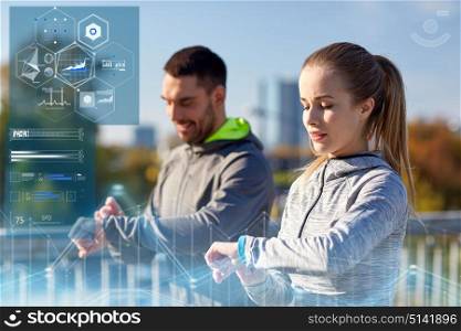 fitness, sport and technology concept - couple with heart-rate trackers exercising outdoors. couple with heart-rate trackers training outdoors