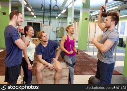 fitness, sport, exercising and healthy lifestyle concept - group of happy people with skipping rope and medicine ball in gym. group of friends with sports equipment in gym