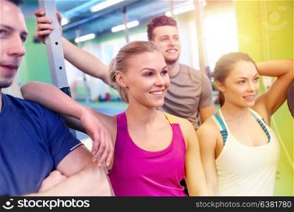 fitness, sport, exercising and healthy lifestyle concept - group of happy people in gym. group of happy friends in gym