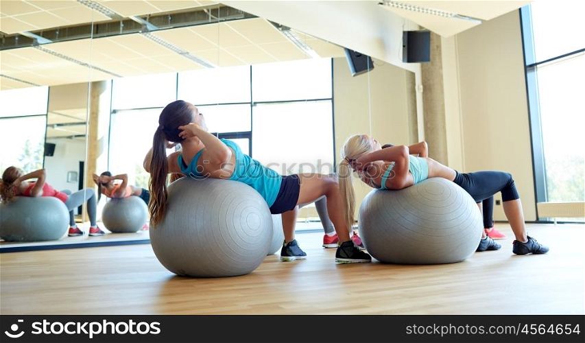 fitness, sport, exercising and lifestyle concept - group of women with exercise balls in gym