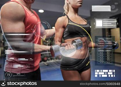 fitness, sport, exercising and weightlifting concept - young woman and personal trainer with dumbbells flexing muscles in gym over virtual charts. young couple with dumbbell flexing muscles in gym