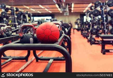 fitness, sport, exercising, weightlifting and bodybuilding concept - close up of kettlebell and medicine ball with sports equipment in gym. medicine ball and sports equipment in gym