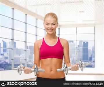 fitness, sport, fitness and people concept - smiling woman with dumbbells flexing biceps over gym or home background