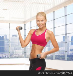 fitness, sport, fitness and people concept - smiling woman with light weight dumbbells flexing biceps over gym or home background