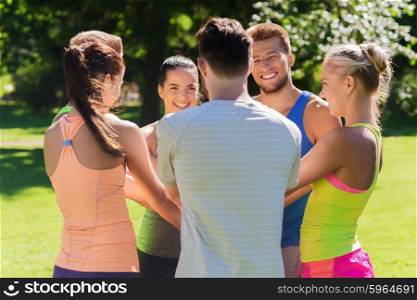 fitness, sport, friendship and healthy lifestyle concept - group of happy teenage friends or sportsmen with hands on top outdoors