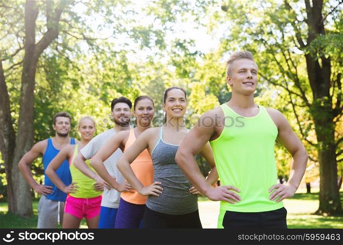 fitness, sport, friendship and healthy lifestyle concept - group of happy teenage friends or sportsmen outdoors