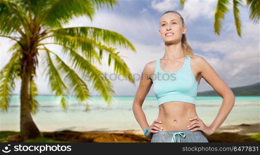 fitness, sport, friendship and healthy lifestyle concept - happy young woman doing sports over tropical beach background in french polynesia. happy young woman doing sports outdoors. happy young woman doing sports outdoors