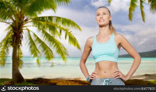 fitness, sport, friendship and healthy lifestyle concept - happy young woman doing sports over tropical beach background in french polynesia. happy young woman doing sports outdoors. happy young woman doing sports outdoors