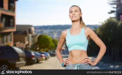fitness, sport, friendship and healthy lifestyle concept - happy young woman doing sports over san francisco city background. happy young woman doing sports outdoors. happy young woman doing sports outdoors