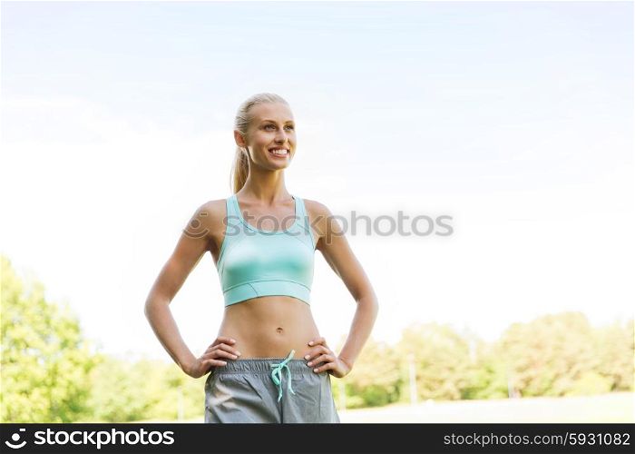 fitness, sport, friendship and healthy lifestyle concept - happy young woman exercising outside