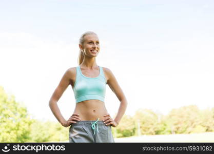 fitness, sport, friendship and healthy lifestyle concept - happy young woman exercising outside