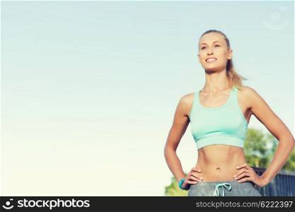fitness, sport, friendship and healthy lifestyle concept - happy young woman exercising outside