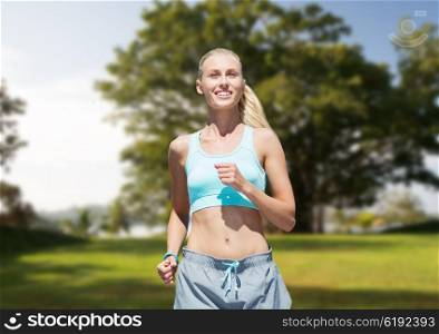 fitness, sport, friendship and healthy lifestyle concept - smiling young woman running or jogging over summer park background