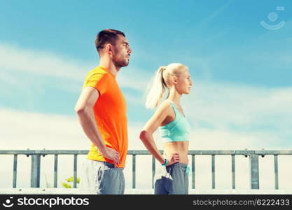 fitness, sport, friendship and healthy lifestyle concept - sporty couple outdoors