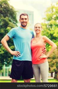 fitness, sport, friendship and lifestyle concept - smiling couple outdoors