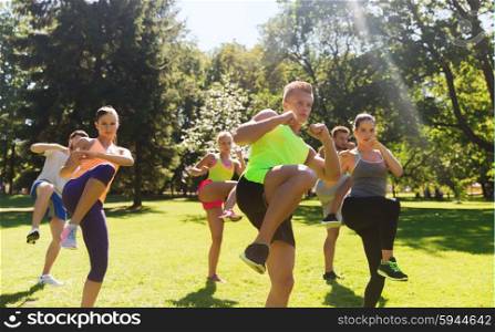 fitness, sport, martial arts, self-defense and healthy lifestyle concept - group of teenage friends or sportsmen exercising and at boot camp
