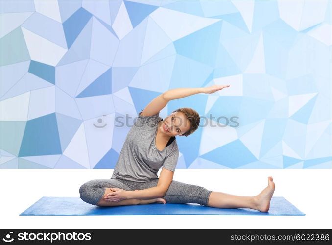 fitness, sport, people and healthy lifestyle concept - happy woman making yoga and stretching on mat over low poly background