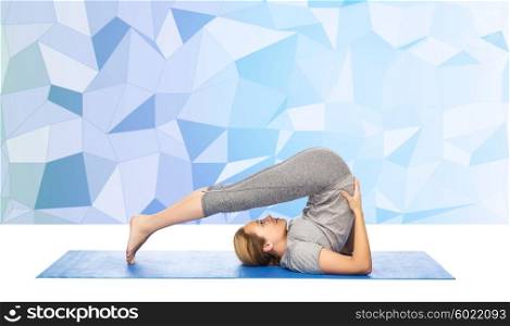 fitness, sport, people and healthy lifestyle concept - woman making yoga in plow pose on mat over low poly background