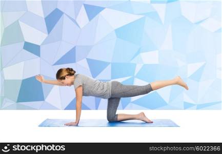 fitness, sport, people and healthy lifestyle concept - woman making yoga in balancing table pose on mat over low poly background