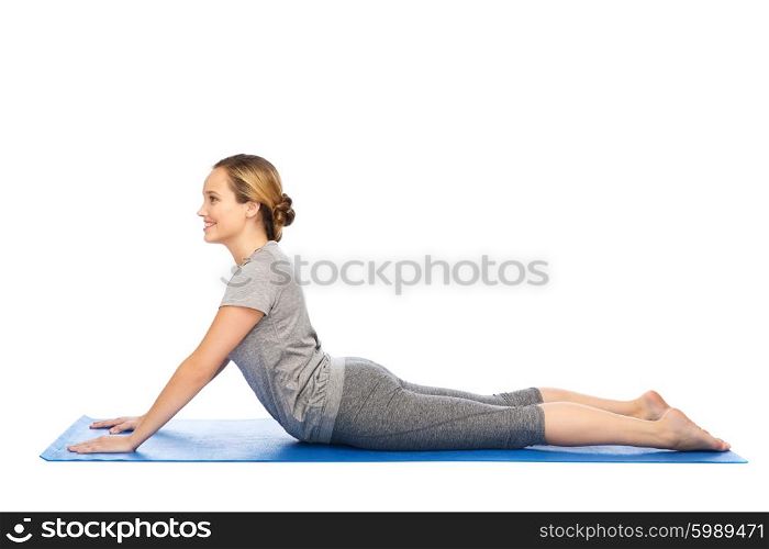 fitness, sport, people and healthy lifestyle concept - woman making yoga in dog pose on mat