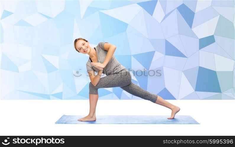 fitness, sport, people and healthy lifestyle concept - woman making yoga low angle lunge pose on mat over blue polygonal background