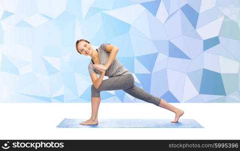 fitness, sport, people and healthy lifestyle concept - woman making yoga low angle lunge pose on mat over blue polygonal background