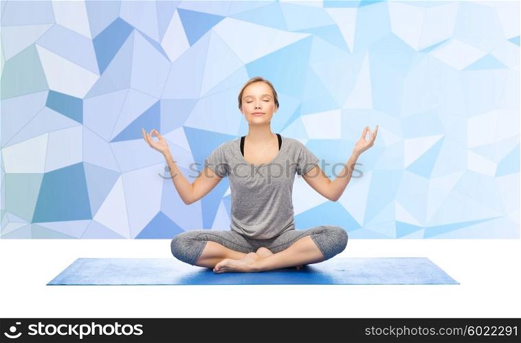 fitness, sport, people and healthy lifestyle concept - woman making yoga meditation in lotus pose on mat over low poly background