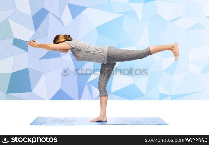 fitness, sport, people and healthy lifestyle concept - woman making yoga warrior pose on mat over low poly background